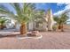 Beautiful stucco home features desert landscaping, a multi-car garage, and mature palm trees at 7973 Macklin St, Las Vegas, NV 89129