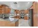 Charming kitchen with granite counters, tile backsplash, stainless steel appliances, and wood cabinets at 7973 Macklin St, Las Vegas, NV 89129