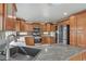 Updated kitchen with granite counters, stainless steel appliances, and tile floors at 7973 Macklin St, Las Vegas, NV 89129