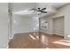 Bright living room with hardwood floors, ceiling fan and a window at 7973 Macklin St, Las Vegas, NV 89129