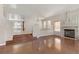 Inviting living room features hardwood floors, a fireplace, and access to the dining area at 7973 Macklin St, Las Vegas, NV 89129