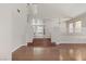 Spacious living room featuring hardwood floors, a staircase, and an open floor plan at 7973 Macklin St, Las Vegas, NV 89129
