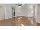 Spacious living room with hardwood floors, a ceiling fan and a laundry room in background at 7973 Macklin St, Las Vegas, NV 89129