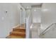 Hallway featuring wood stairs, white railing, and neutral color scheme at 7973 Macklin St, Las Vegas, NV 89129