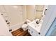 Bathroom with a shower-tub combo, single vanity with a white countertop, and wood-look flooring at 8216 Chimney Bluffs St, North Las Vegas, NV 89085