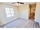 Bedroom features neutral paint, carpet and ceiling fan with en suite bathroom and view of the staircase at 8216 Chimney Bluffs St, North Las Vegas, NV 89085