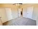 Bedroom with neutral paint, carpet, closet and ceiling fan and view of the staircase at 8216 Chimney Bluffs St, North Las Vegas, NV 89085