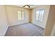 Bedroom featuring neutral paint, carpet, ceiling fan, and two windows for natural light at 8216 Chimney Bluffs St, North Las Vegas, NV 89085
