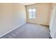 Bedroom featuring neutral paint, carpet, ceiling fan, and a window with views of the backyard at 8216 Chimney Bluffs St, North Las Vegas, NV 89085