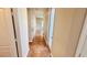 Neutral-colored hallway featuring tile floors and white doors at 8216 Chimney Bluffs St, North Las Vegas, NV 89085