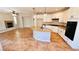 Open kitchen with granite countertops, white cabinets, and tile flooring adjoining living area at 8216 Chimney Bluffs St, North Las Vegas, NV 89085