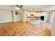 Open-concept living room and kitchen area with tile floors and white cabinets at 8216 Chimney Bluffs St, North Las Vegas, NV 89085