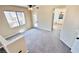 Bright living room featuring plush carpeting, balcony access, and bathroom access at 8216 Chimney Bluffs St, North Las Vegas, NV 89085