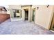 A charming patio area with attractive paver stones and neutral stucco walls at 8216 Chimney Bluffs St, North Las Vegas, NV 89085