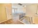 Upstairs hallway with carpet, a metal railing and a door at 8216 Chimney Bluffs St, North Las Vegas, NV 89085