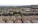 An aerial view showcases a neighborhood of tan, two-story homes with tile roofs in a well-maintained community at 9748 Villa Lorena Ave, Las Vegas, NV 89147