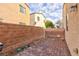 Spacious backyard featuring a brick privacy fence and paver patio, perfect for outdoor living at 9748 Villa Lorena Ave, Las Vegas, NV 89147