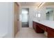 Bathroom with dual vanities, tile floor, and bright lighting at 9748 Villa Lorena Ave, Las Vegas, NV 89147