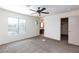 Carpeted bedroom with ceiling fan and natural light from the circular window at 9748 Villa Lorena Ave, Las Vegas, NV 89147
