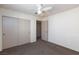 Bedroom featuring a ceiling fan, plush carpeting, and a mirrored closet at 9748 Villa Lorena Ave, Las Vegas, NV 89147