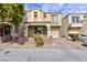 Two story home with stucco and stone exterior, desert landscaping, and an attached one car garage at 9748 Villa Lorena Ave, Las Vegas, NV 89147