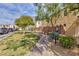 Landscaped community with a lush green lawn and sidewalks at 9748 Villa Lorena Ave, Las Vegas, NV 89147