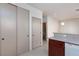 Hallway featuring tile floors, storage closet, and view of the kitchen and bathroom at 9748 Villa Lorena Ave, Las Vegas, NV 89147