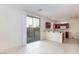 Spacious open kitchen with a breakfast bar, dark cabinets, and a sliding glass door at 9748 Villa Lorena Ave, Las Vegas, NV 89147