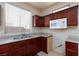 Modern kitchen with dark cabinetry, sleek countertops, and stainless steel appliances at 9748 Villa Lorena Ave, Las Vegas, NV 89147