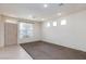 Spacious living room with plush carpeting, recessed lighting, and a large window for natural light at 9748 Villa Lorena Ave, Las Vegas, NV 89147