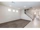 Bright and airy living room with plush carpeting, recessed lighting, and staircase access at 9748 Villa Lorena Ave, Las Vegas, NV 89147