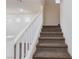 Carpeted staircase with white railing leading to the upper level of the home at 9748 Villa Lorena Ave, Las Vegas, NV 89147