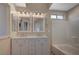 The bathroom features double sinks, decorative mirrors, and a shower-tub combo for a luxurious experience at , Las Vegas, NV 89106