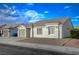 Charming single-story home featuring a well-maintained front yard with a one car garage and beautiful blue sky at , Las Vegas, NV 89106