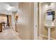 Powder room with pedestal sink and view into the laundry room, adjacent to the kitchen at 10066 Delicate Dew St, Las Vegas, NV 89183