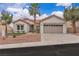 Charming single-story home features a desert landscape, a two-car garage, and a terracotta tile roof at 10329 Bent Brook Pl, Las Vegas, NV 89134