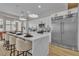 Bright kitchen with white countertops, island seating, and stainless steel fridge at 10329 Bent Brook Pl, Las Vegas, NV 89134