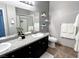 Bathroom featuring double sinks, granite counters, and a tiled shower at 10553 Pine Pointe Ave # 201, Las Vegas, NV 89144