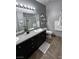 Bathroom featuring double sinks, granite counters, and a tiled shower at 10553 Pine Pointe Ave # 201, Las Vegas, NV 89144