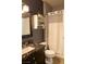 Bathroom with granite countertop, vanity, toilet, and shower with white curtain at 10553 Pine Pointe Ave # 201, Las Vegas, NV 89144