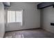 Carpeted Bedroom featuring a large window and neutral walls at 10553 Pine Pointe Ave # 201, Las Vegas, NV 89144