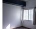 Bright bedroom corner featuring a sunny window with privacy blinds and white curtains at 10553 Pine Pointe Ave # 201, Las Vegas, NV 89144
