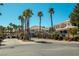 Well-maintained condo complex with mature palm trees, manicured lawns, and a secure gated entrance at 10553 Pine Pointe Ave # 201, Las Vegas, NV 89144