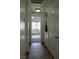 Hallway with tile floors leading to a bedroom with a sunlit window at 10553 Pine Pointe Ave # 201, Las Vegas, NV 89144