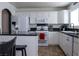 Bright kitchen featuring white cabinets, granite counters, and stainless steel appliances at 10553 Pine Pointe Ave # 201, Las Vegas, NV 89144