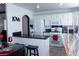 Eat-in kitchen featuring white cabinetry, black granite countertops, and modern appliances at 10553 Pine Pointe Ave # 201, Las Vegas, NV 89144