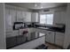 Modern kitchen with stainless appliances, white cabinets, and an island with bar seating at 10553 Pine Pointe Ave # 201, Las Vegas, NV 89144