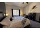 Bright main bedroom showcasing minimalist decor, soft lighting, and a white comforter at 10553 Pine Pointe Ave # 201, Las Vegas, NV 89144