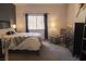 Bedroom with a queen size bed with zebra print ottoman and dark wood furnishings at 10553 Pine Pointe Ave # 201, Las Vegas, NV 89144
