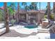 Relaxing pool area featuring a spa, shaded seating, and desert landscaping for a tranquil retreat at 10553 Pine Pointe Ave # 201, Las Vegas, NV 89144